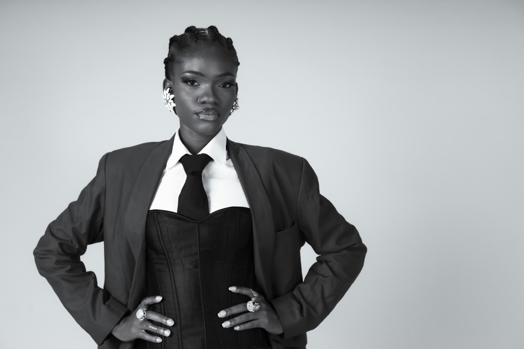 Black woman business owner standing confidently with her hands on her hips, ready to rethink the friends and family discount