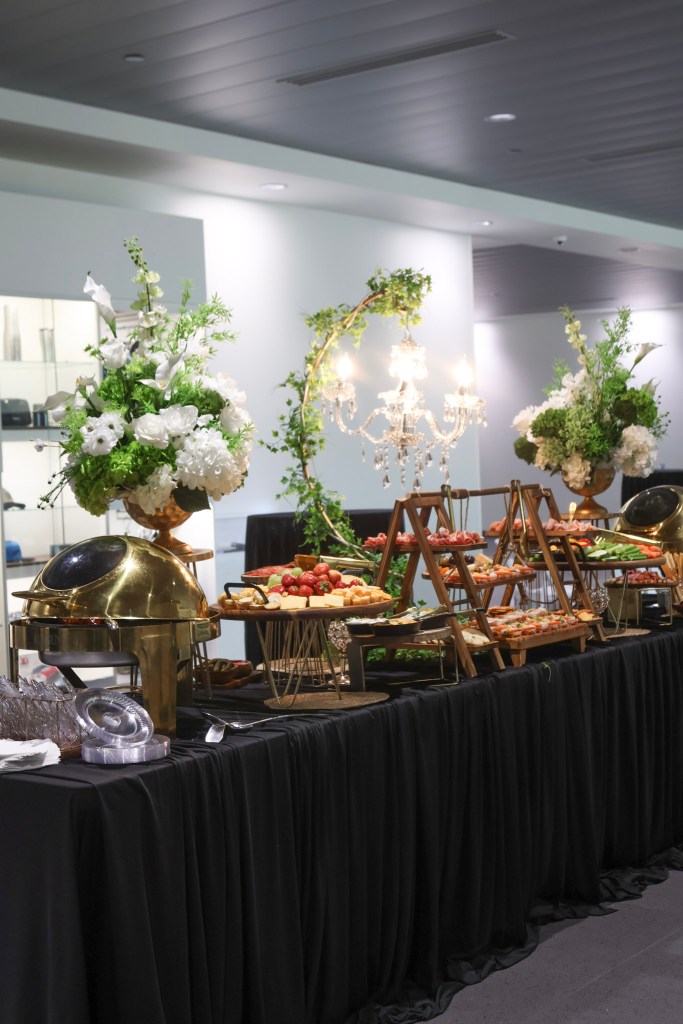 Catered appetizers and floral display at The Legacy League Women's Legal Playbook evening at Porsche Chantilly