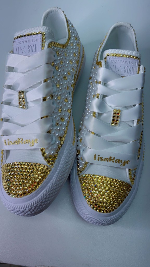 White pearl and gold rhinestone sneakers with LisaRaye on the laces, designed by Jillian Lee